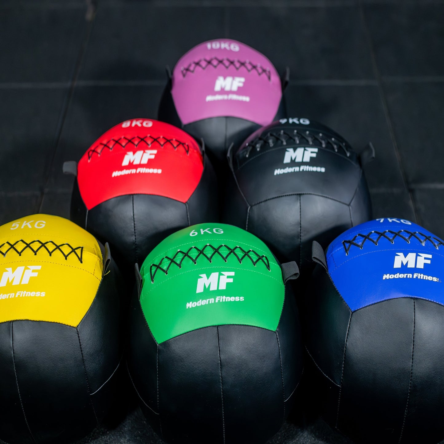 modernfitness color-coded wall balls in various weights from 5kg to 10kg with durable textured PU construction