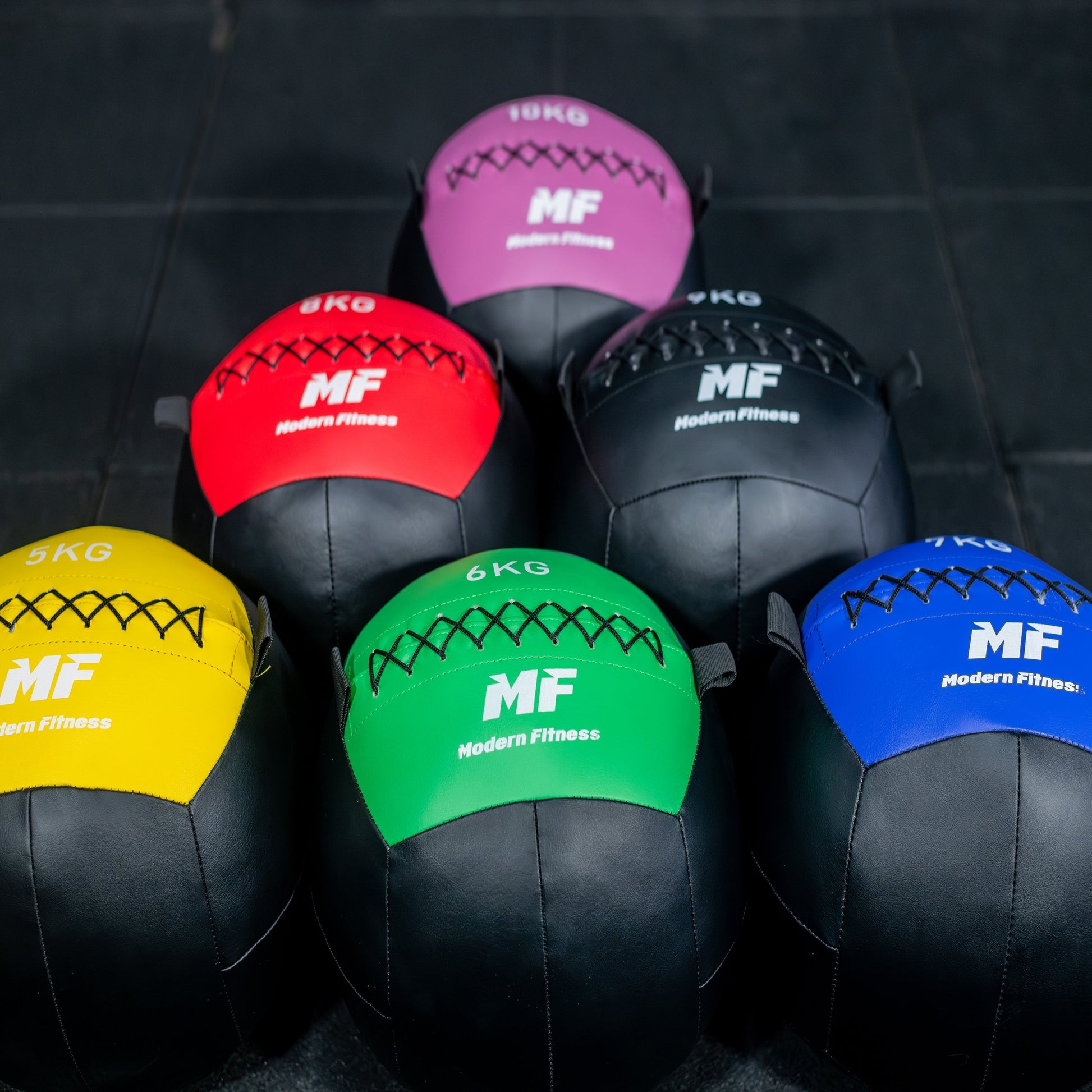 modernfitness color-coded wall balls in various weights from 5kg to 10kg with durable textured PU construction