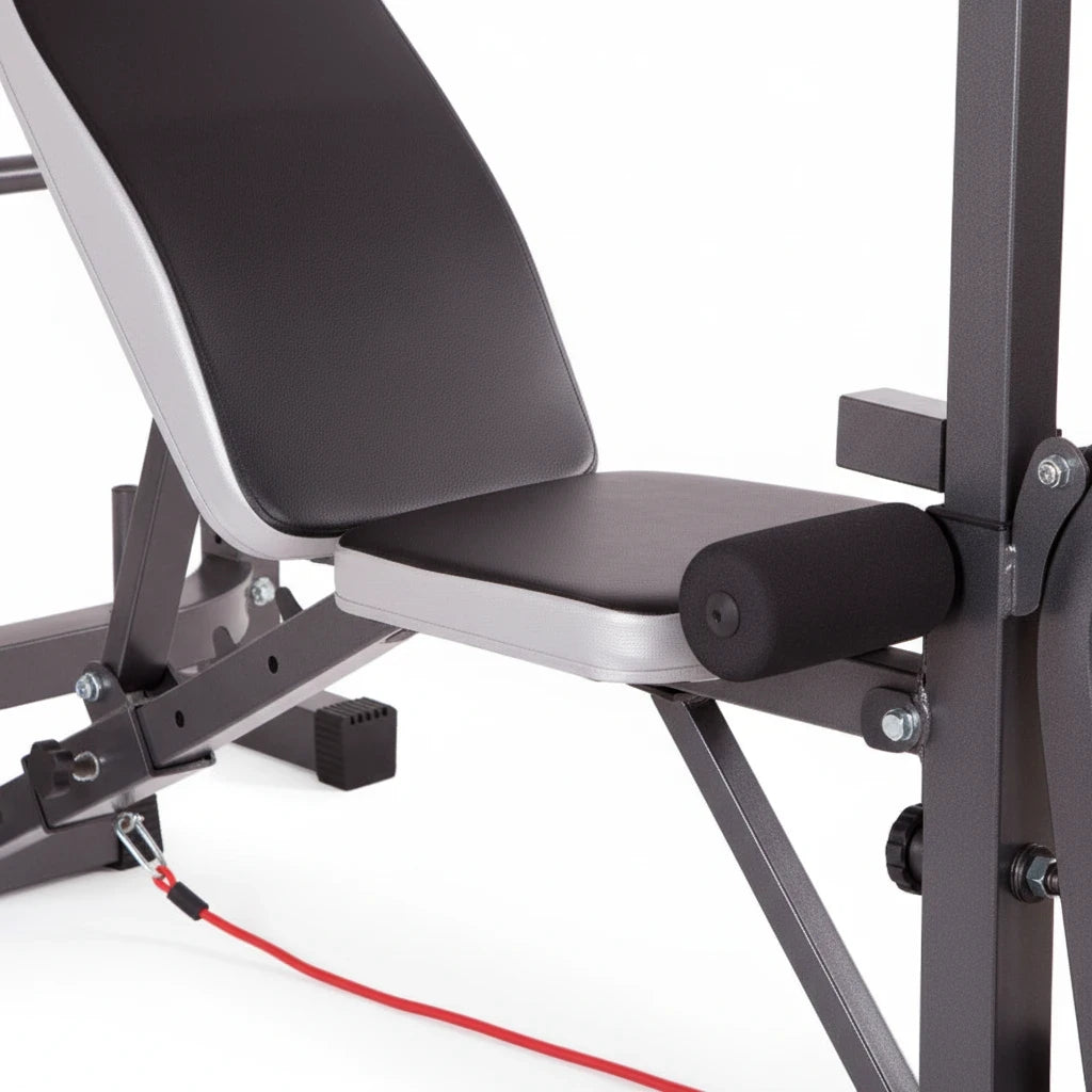 modernfitness multi-station weight bench with black padded seat, leg extension attachment, and grey steel frame.