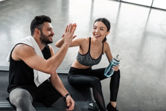 Gym Workouts For Beginners blog by Modern Fitness- two people in a gym completing a workout